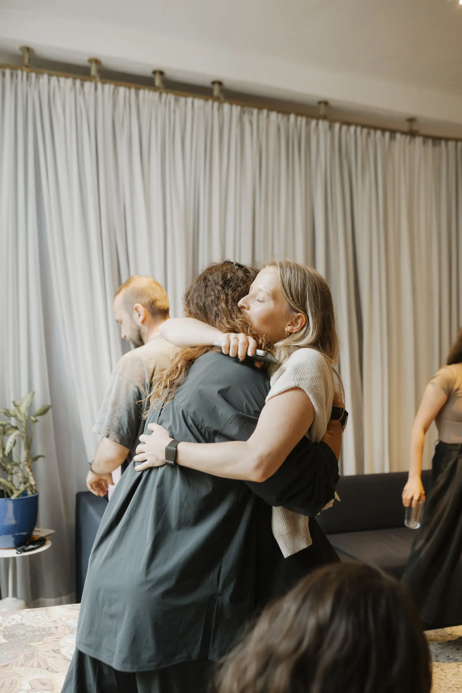 Two participants embracing at the end of a programme.