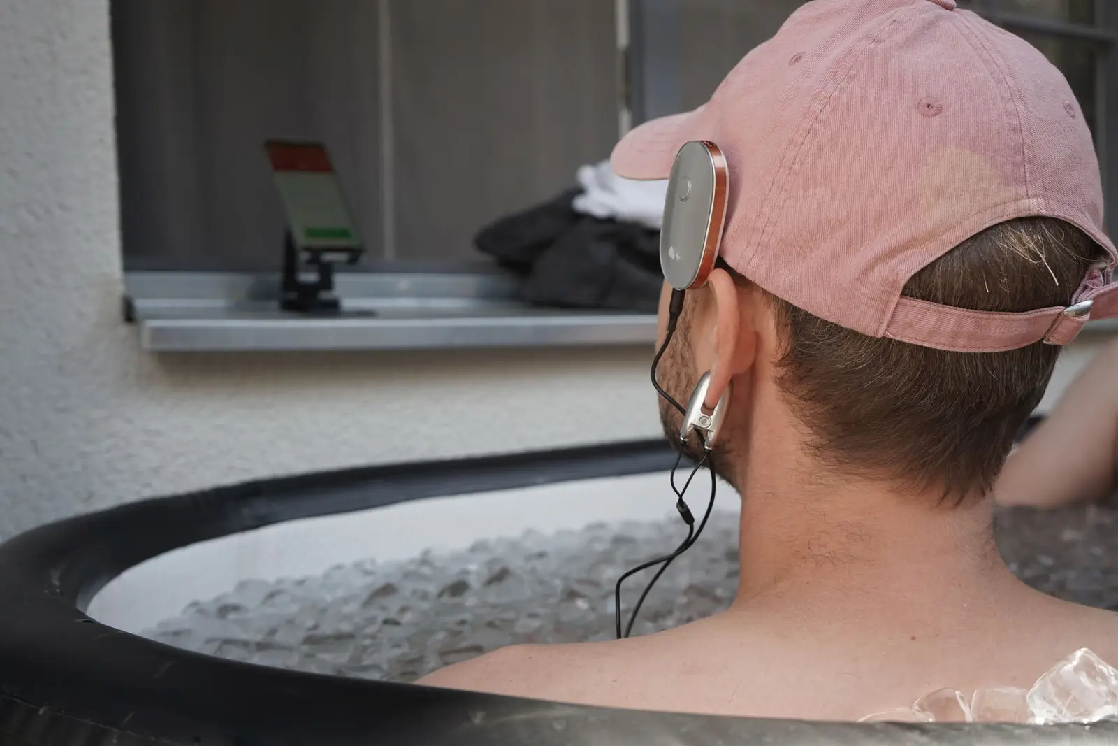 A participant in an ice bath wearing a physiological monitor.