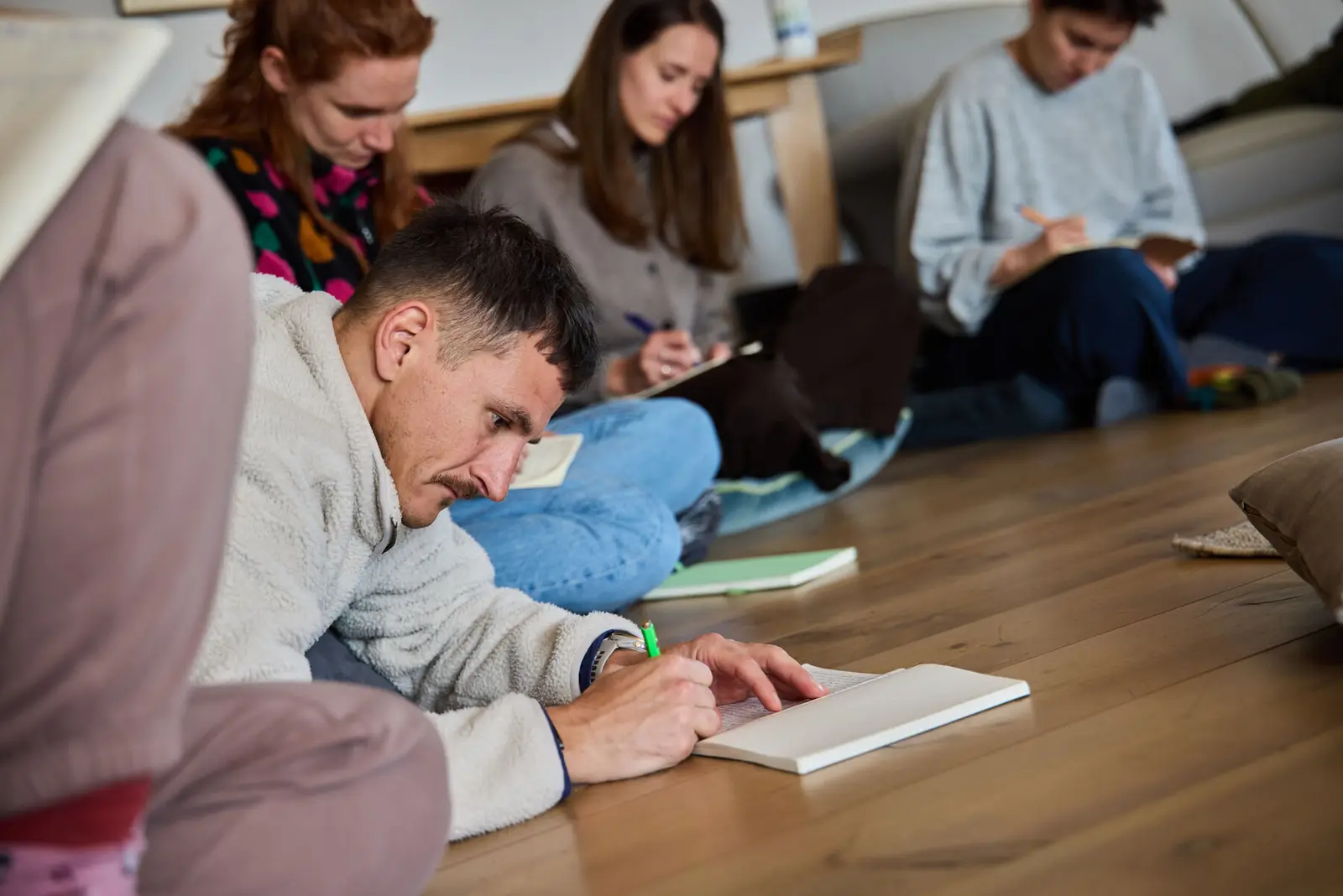 Participants writing on the floor during an integration session.