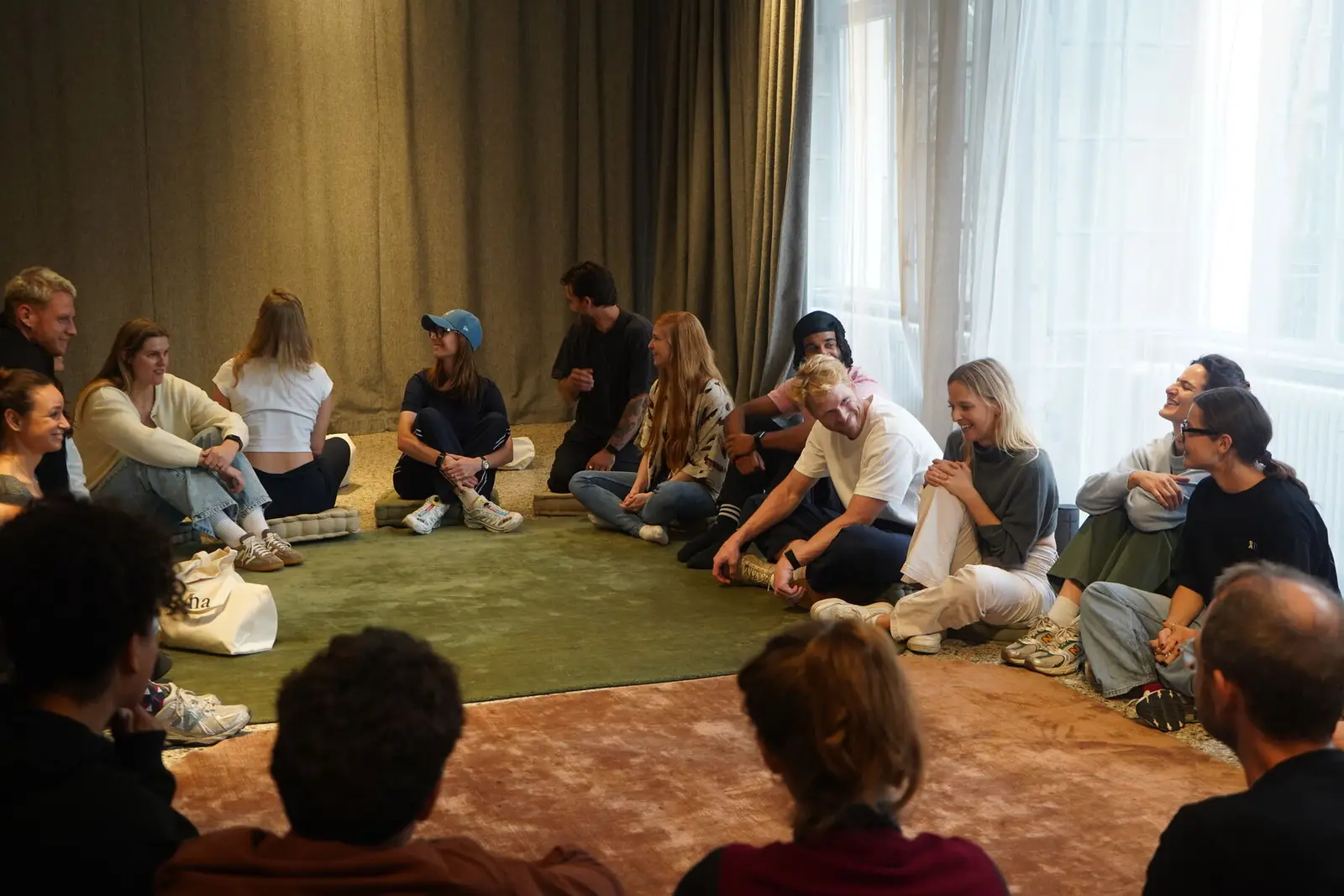 A seated circle session in a bright room.